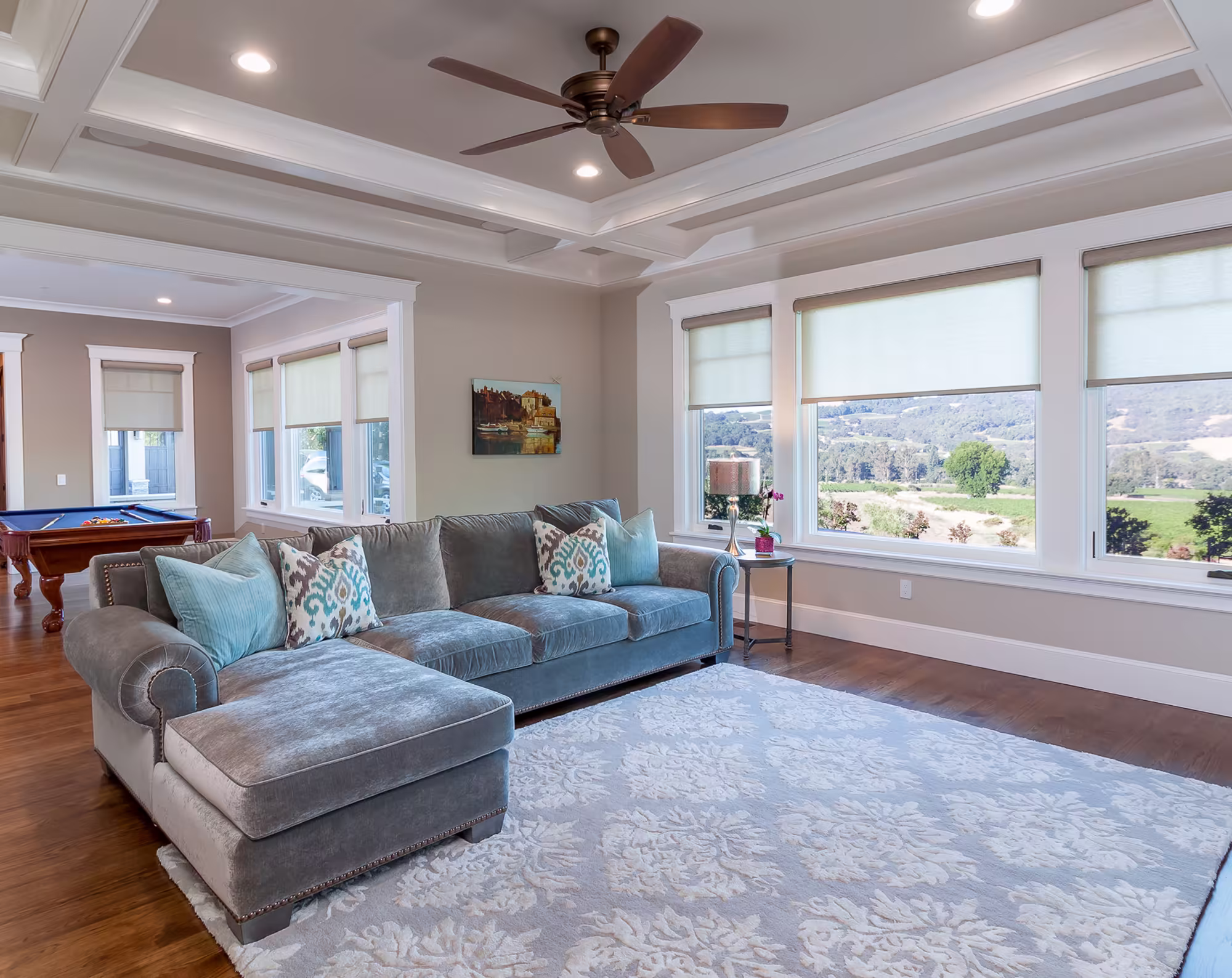Billiards room with coffered ceiling and vineyard views